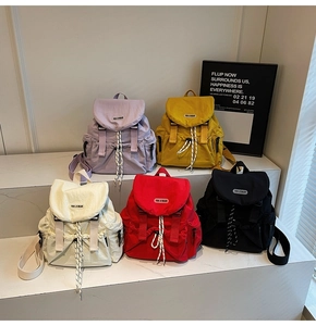 Detailed view of lightweight nylon backpacks in five vibrant colors with buckle closure