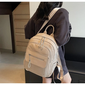 Detail of apricot pebbled leather backpack with a geometric pattern woven wide strap