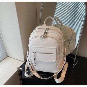 Detail of white litchi grain texture on backpack with woven pattern strap