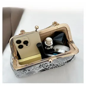Detail showing the spacious interior of this vintage floral shell bag with daily essentials