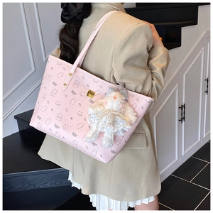 Pink tote bag with bear print and bunny charm on black minimalist indoor stairs