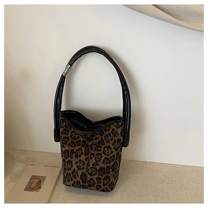 Detail of leopard print bucket bag with black handle and silver metal ring hardware