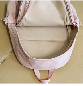 Detail of internal padded laptop compartment and large main storage in pink backpack