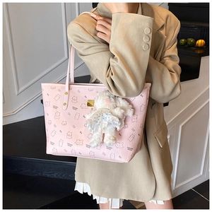 Pink printed tote bag detail with cute bear patterns and a plush bunny charm