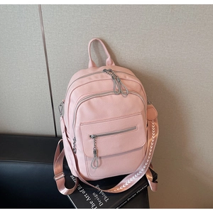 Close-up of pink lychee textured leather backpack with ethnic woven shoulder strap