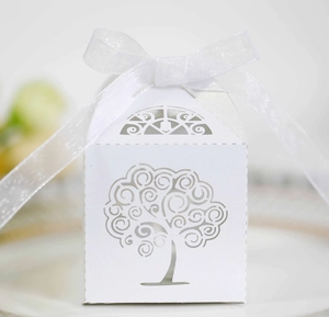 Detailed laser-cut tree of life design on white gift box with elegant white silk ribbon