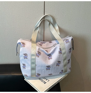 Close-up of quilted waffle fabric featuring cute cartoon bear patterns on a travel bag