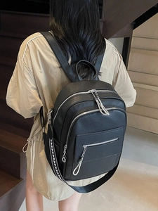 Litchi pattern black leather backpack with silver hardware and geometric strap