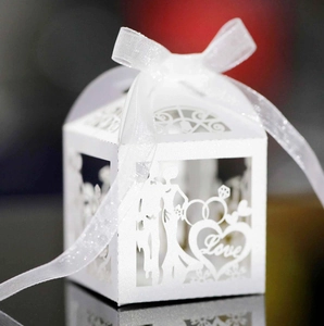 White laser-cut wedding favor box with Love text, couple silhouette and organza ribbon bow