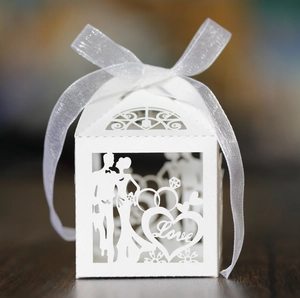 Detailed laser cut white wedding favor box with Love text and bride groom silhouettes