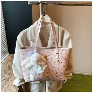 Pink tote bag with bear print and cute bunny plush charm on a white blazer