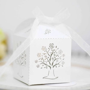 Close-up of white laser-cut rose tree favor box with elegant organza ribbon bow