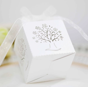Close-up of white European candy box featuring silver laser-cut hollow tree design