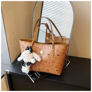 Brown tote bag with cute animal prints and a decorative white bunny charm