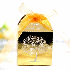 Golden laser-cut tree favor box with orange ribbon for weddings and parties