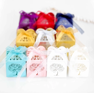 Detailed laser-cut tree of life candy boxes with elegant organza ribbons in various colors