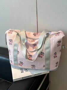 Pink seersucker travel bag with cartoon dog print and separate wet dry bottom compartment