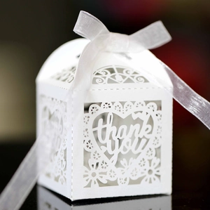 Elegant laser cut white heart wedding favor box with thank you text and ribbon