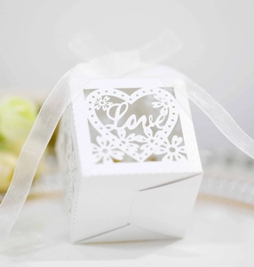 Macro detail of white hollow Love heart candy box with elegant satin ribbon closure
