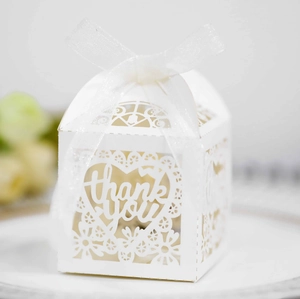 Detail of laser cut lace heart gift box with thank you text and white ribbon bow