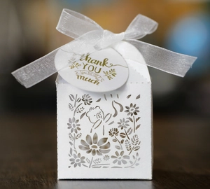 Detail of white laser-cut bear candy box with delicate ribbon and Thank You tag