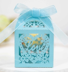 Light blue laser cut candy box featuring a hollow heart and Love design with a ribbon bow