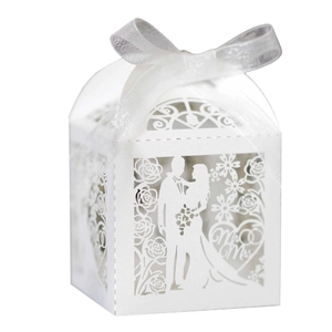 Detail view of pearl white laser-cut wedding candy box with Mr & Mrs ribbon bow