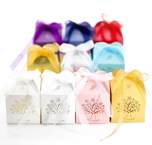 Detailed laser-cut candy boxes with rose tree pattern and elegant organza ribbons