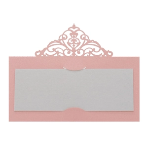 Detail of laser-cut wedding place card with intricate European scroll hollow patterns