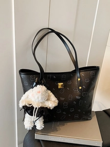 Elegant black tote bag with animal pattern and a cute rabbit plush charm decoration