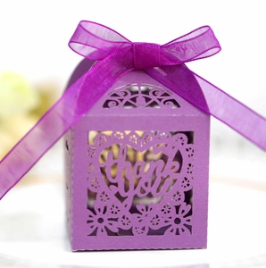 Detail of purple hollow wedding candy box with laser-cut thank you text and silk ribbon
