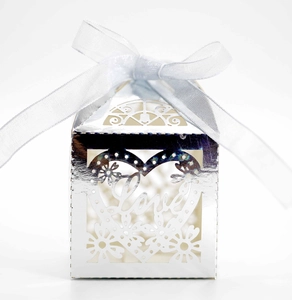 Detail of silver laser-cut wedding candy box with Love heart pattern and ribbon bow