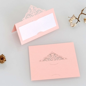 Detail of pink laser cut hollow place card with pearlescent finish and white insert
