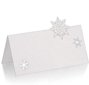 Macro view of white snowflake laser-cut place card with elegant pearl paper texture