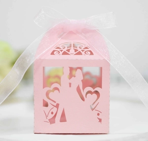 Pink heart laser cut wedding favor box with silhouette design and white ribbon bow