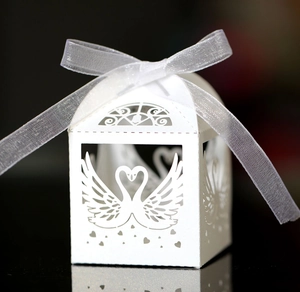 Elegant white laser-cut swan heart wedding favor box with a delicate white organza ribbon