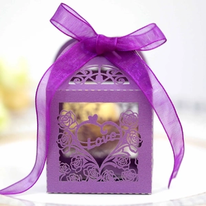 Detail of purple laser-cut candy box with hollow rose pattern and Love text