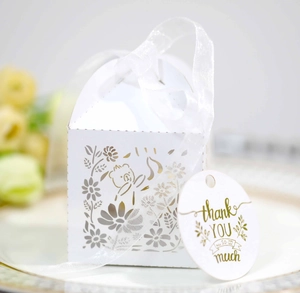 Close-up of white laser-cut gift box with floral rabbit design and thank you tag