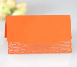 Orange laser cut lace name place cards in tent fold style for elegant table settings