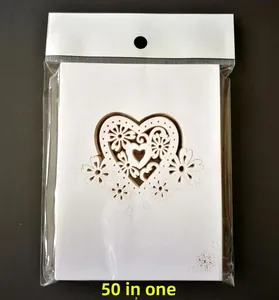 Close-up of laser-cut hollow heart place cards for weddings, white 50-pack set