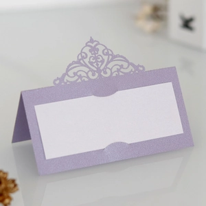 Detailed laser-cut purple place card with intricate European vine patterns and white insert
