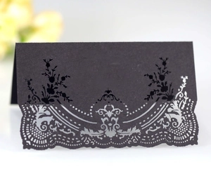 Elegant black laser-cut lace place cards for weddings featuring intricate floral patterns
