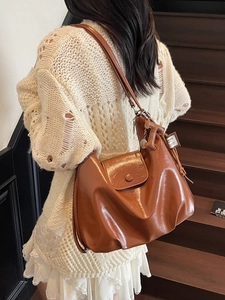 Vintage brown glossy leather shoulder bag with pleated texture and stylish hobo design
