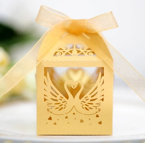 Detailed laser-cut gold swan heart wedding candy box with elegant ribbon bow tie