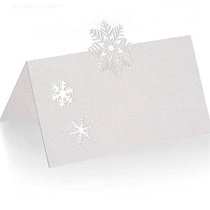 White glitter laser-cut snowflake place cards for Christmas and wedding table settings