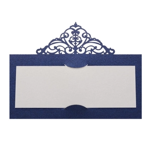 Macro view of navy glitter paper place card with intricate laser cut floral edge