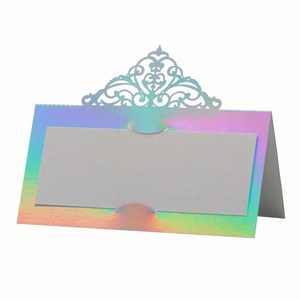 Iridescent laser cut wedding place card with a crown lace design on a white background