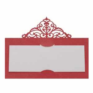 Close-up of red laser-cut hollow floral place card with blank white insert for weddings