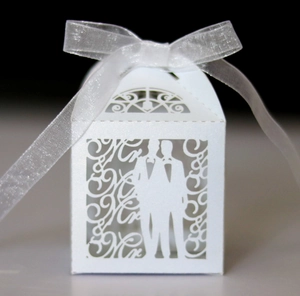Detailed laser-cut Mr & Mr wedding candy box with white pearlescent paper and ribbon bow