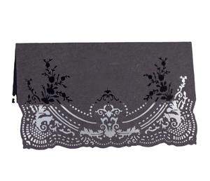 Elegant black laser cut table name cards with intricate lace hollow design for weddings